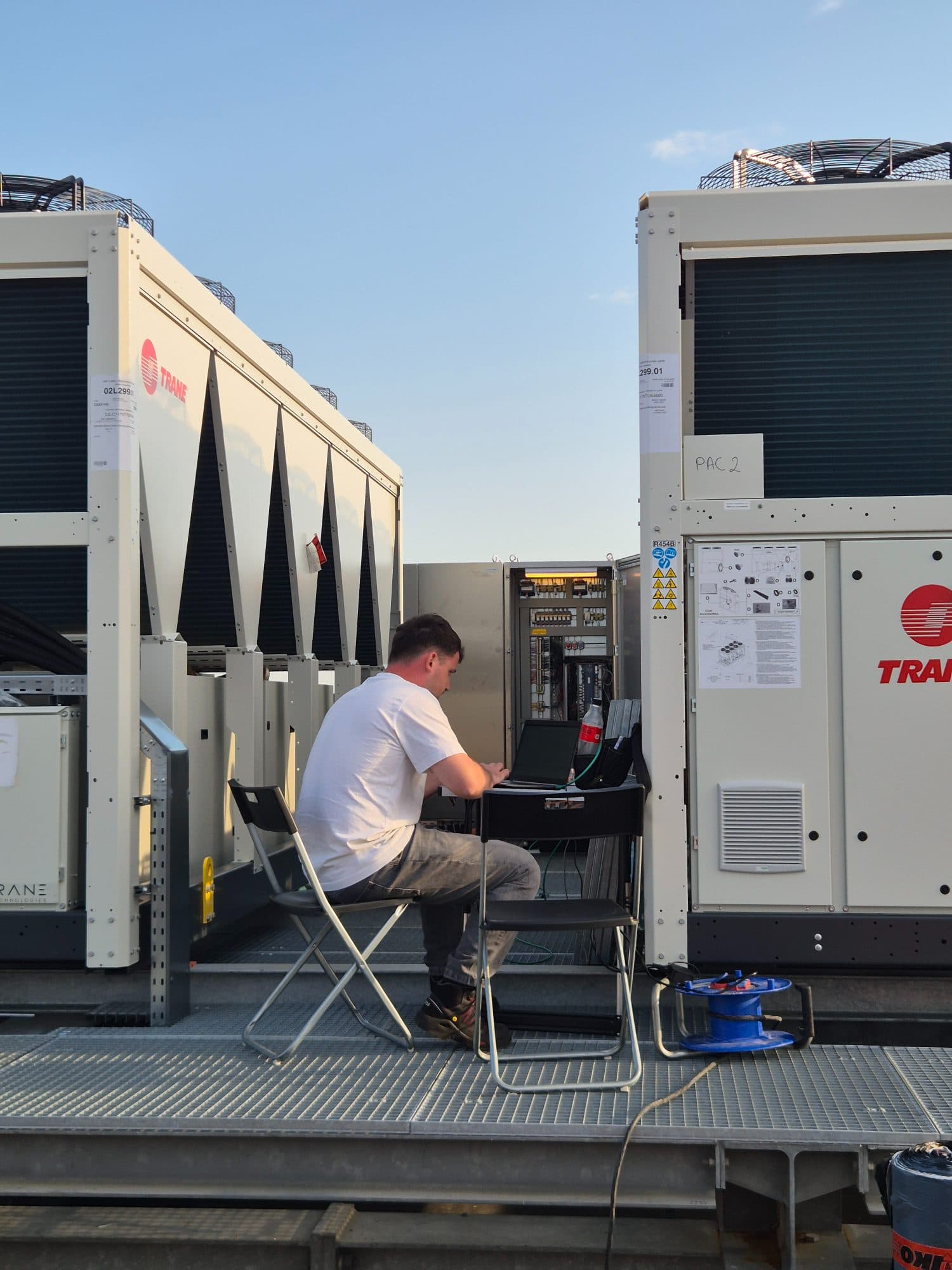 Técnico Alva en obra junto a equipos HVAC y cuadro eléctrico